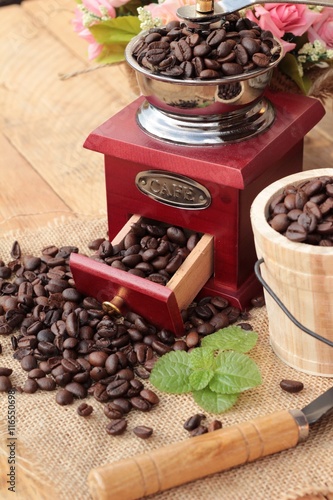 Coffee grinder with coffee beans and cup espresso.