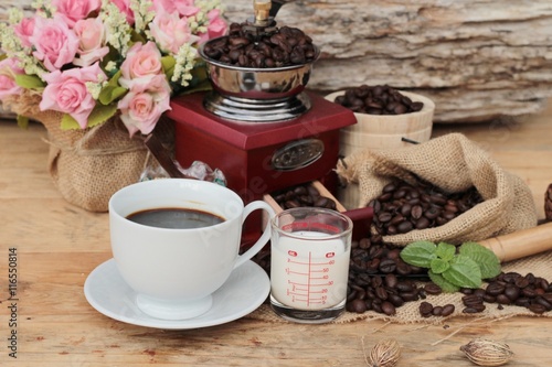 Coffee grinder with coffee beans and cup espresso.