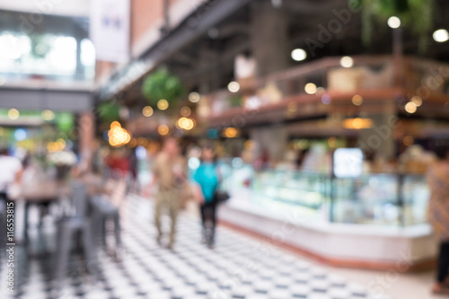 People shopping in market. Defocused blur background.