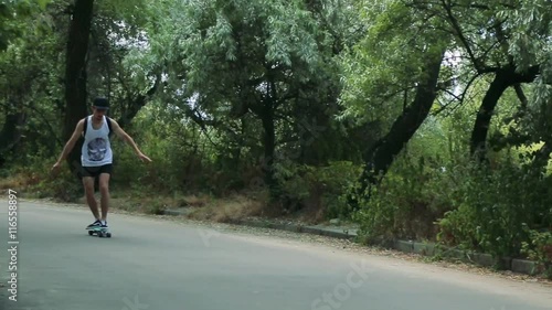 man rides a skateboard on the road photo