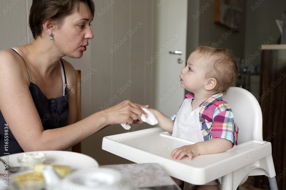 Mother cleaning son hand Mother cleaning son hand
