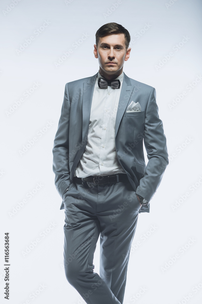 Fototapeta premium Portrait of a elegant handsome business man on white background