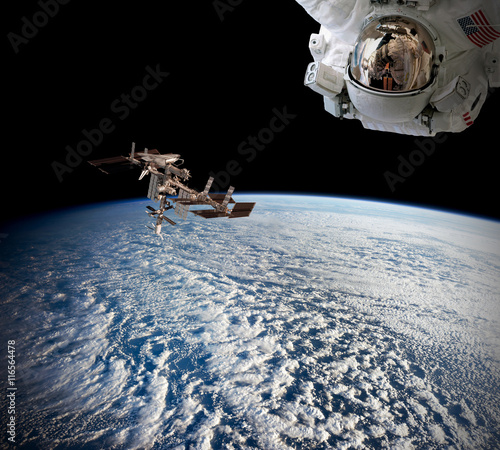 Fototapeta Naklejka Na Ścianę i Meble -  Planet Earth astronaut spaceman helmet suit outer spacewalk international space station. Elements of this image furnished by NASA.