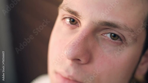 A young man with a half-hearted glance considering meeting. RAW video record.