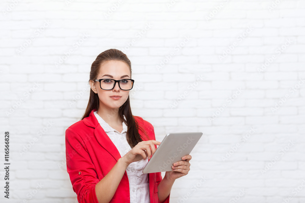 Businesswoman use tablet computer touch screen wear red jacket glasses Businesswoman use tablet computer touch screen wear red jacket glasses