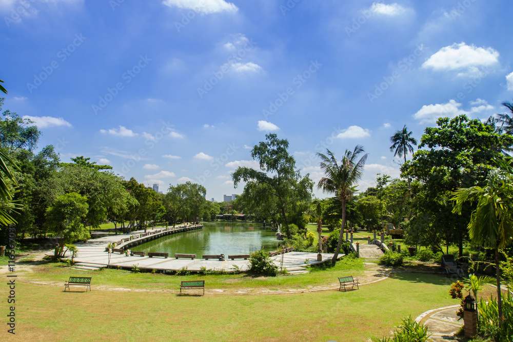 View of blue sky, garden and lake