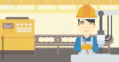 Man working on industrial drilling machine.