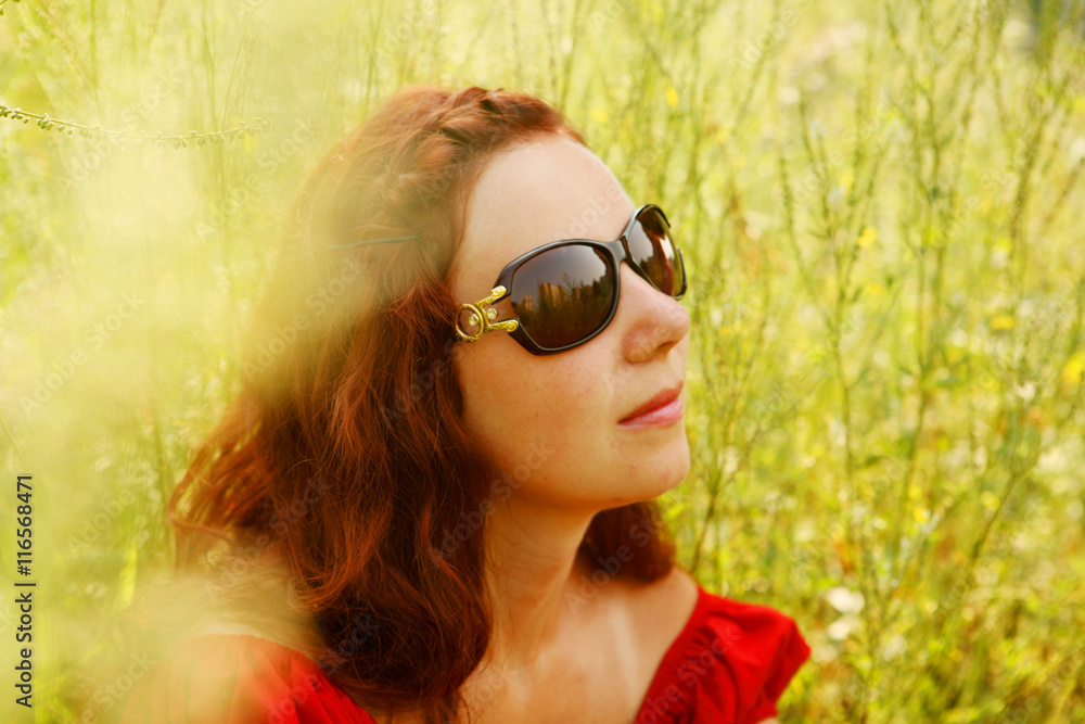 young woman relaxing in the grass young woman relaxing in the grass
