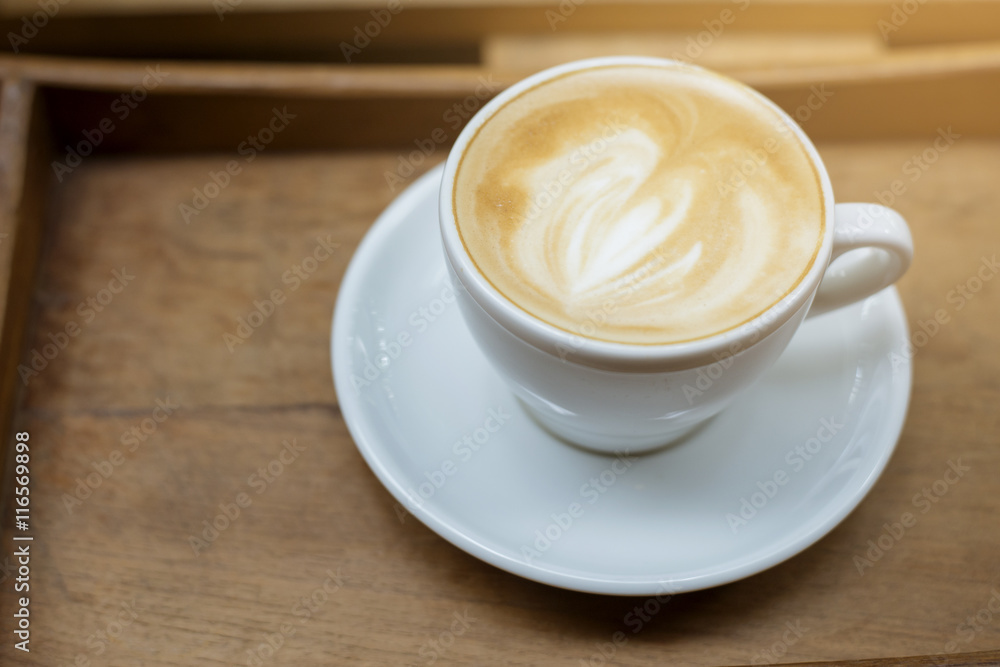 hot latte art on wood table background hot latte art on wood table background