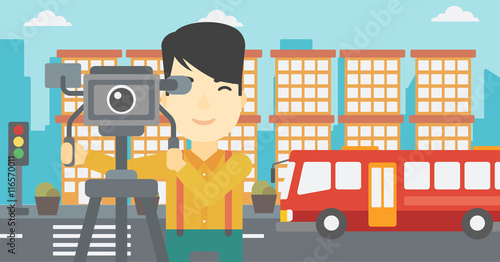 Cameraman with movie camera on tripod.