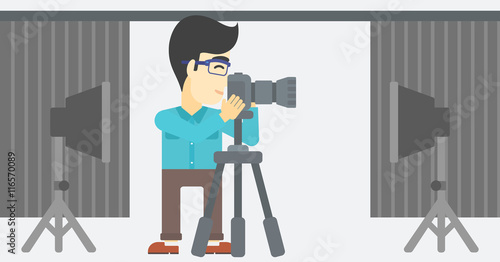 Photographer working with camera on tripod.