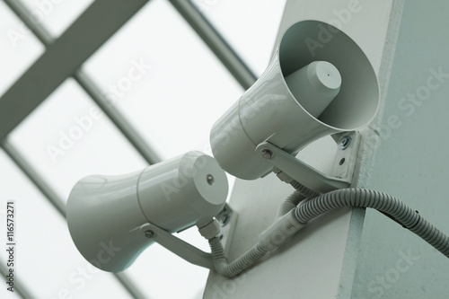 Two twin megaphone on the wall of a building.