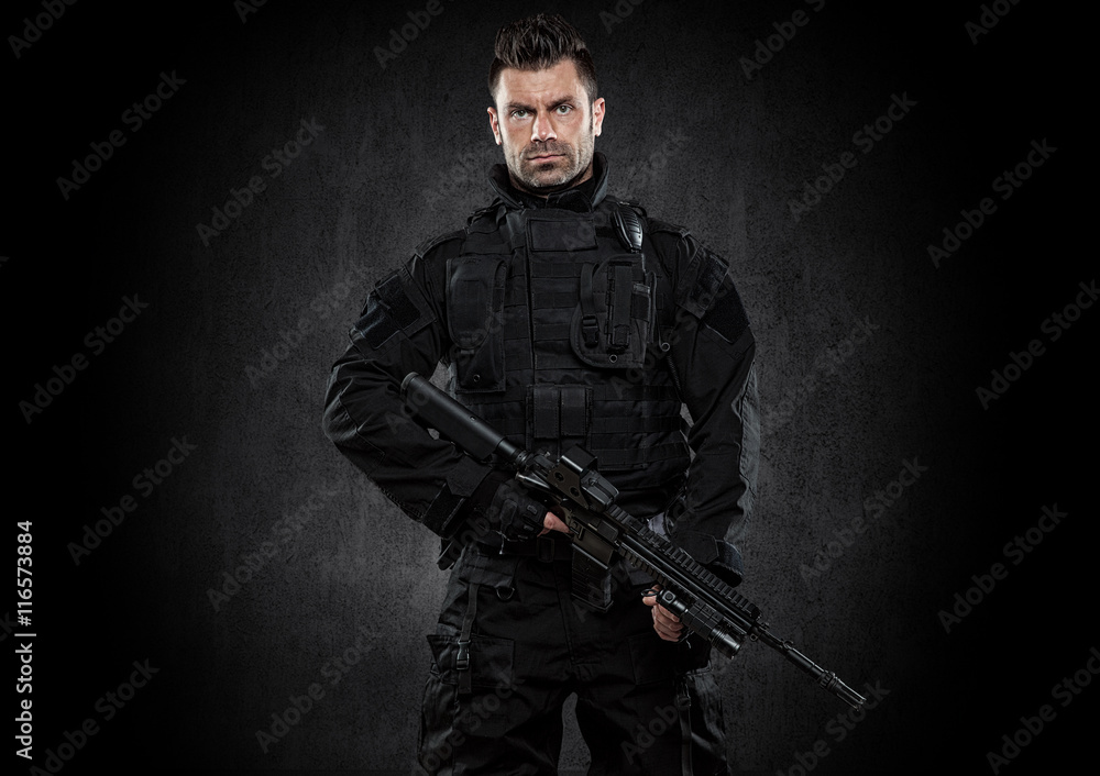 Spec ops police officer SWAT in black uniform studio Spec ops police officer SWAT in black uniform studio