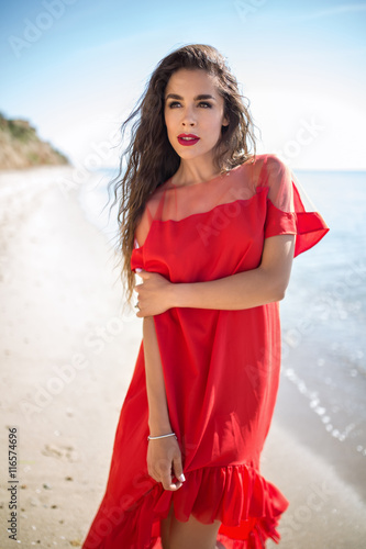 Attractive girl in a smart dress red