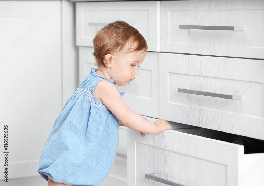 Child playing with cupboard Child playing with cupboard