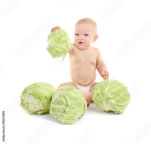 Beautiful baby sitting with green cabbage on white background