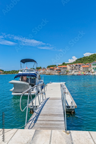 Small boat anchored in the Prvic Luka port at beautiful summer day in Croatia.
