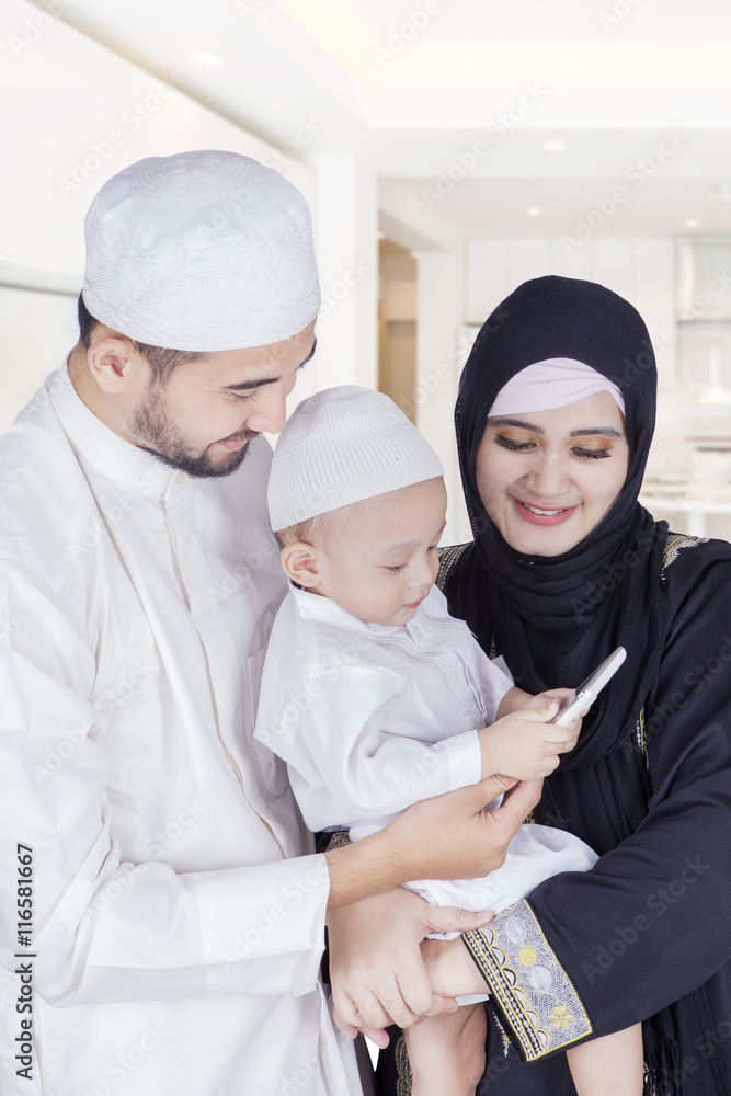 Arabic boy and parents use cellphone Arabic boy and parents use cellphone