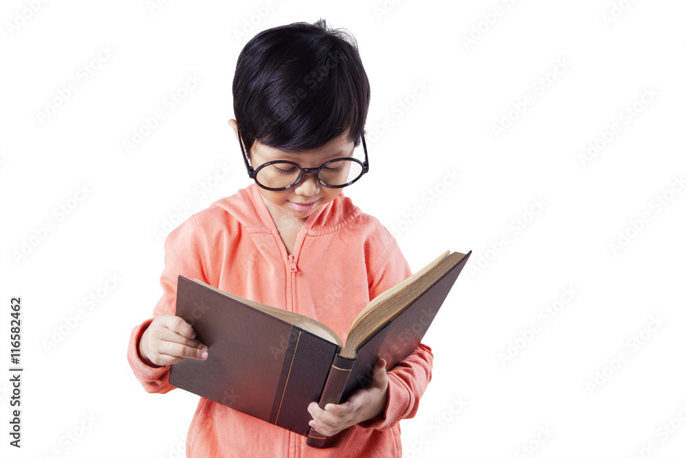 Little schoolgirl reads book in studio Little schoolgirl reads book in studio