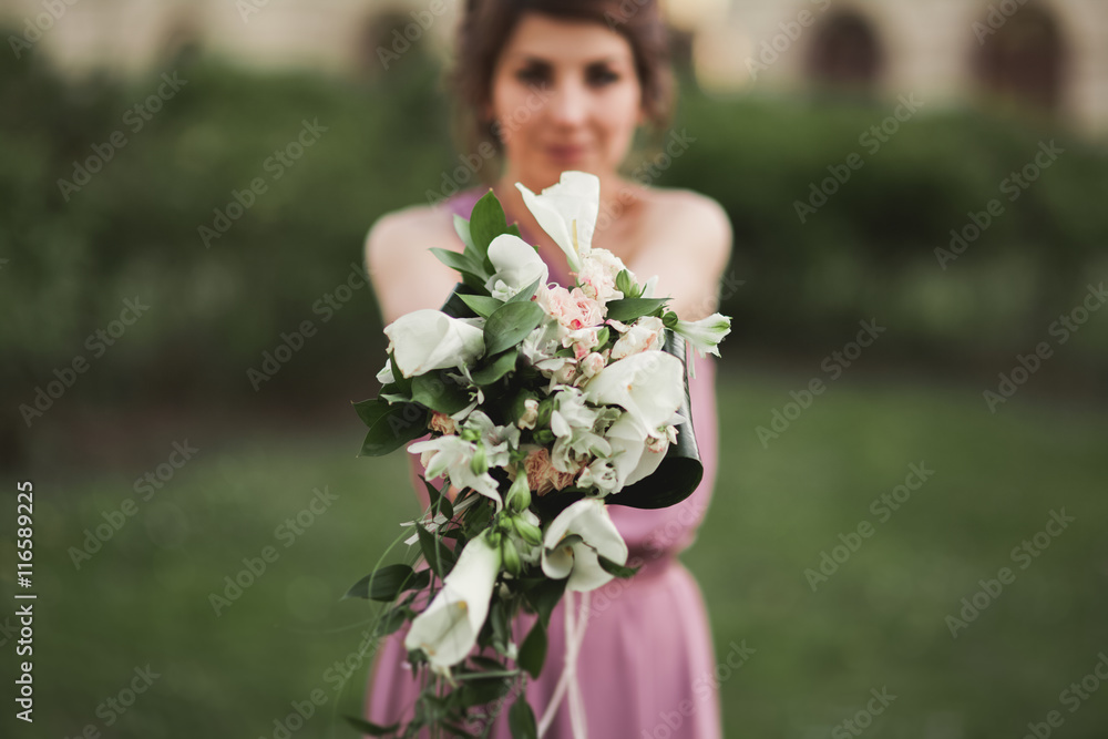 The beautiful woman, bride in pink dress with great bouquet The beautiful woman, bride in pink dress with great bouquet