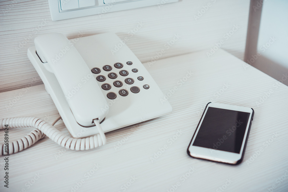 Wired telephone beside cellular smart phone Wired telephone beside cellular smart phone