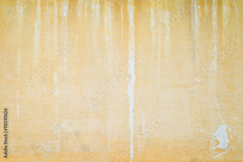 Weathered and aged orange concrete wall, paint peeled off, texture background with vignetting.