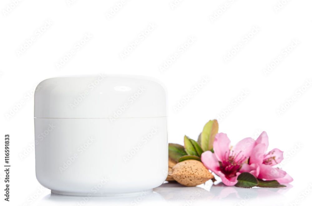 Jar of beauty cream isolated with flowers on white background