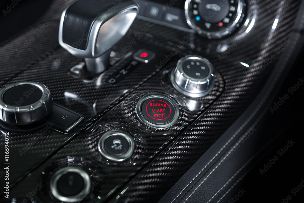 Start/stop engine button detail shot of sports car