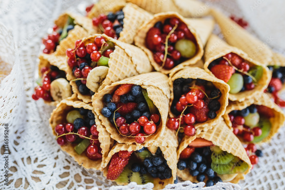 Fototapeta premium Mix of berry fruits in the ice cream cone