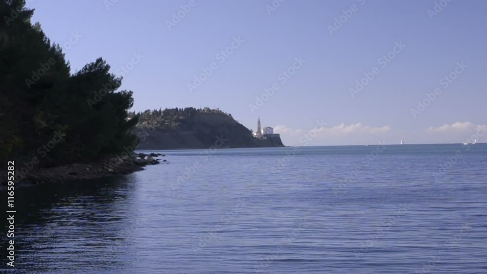 Slovenia. Mediterranean Sea. Wooded Beach and Tower away Slovenia. Mediterranean Sea. Wooded Beach and Tower away