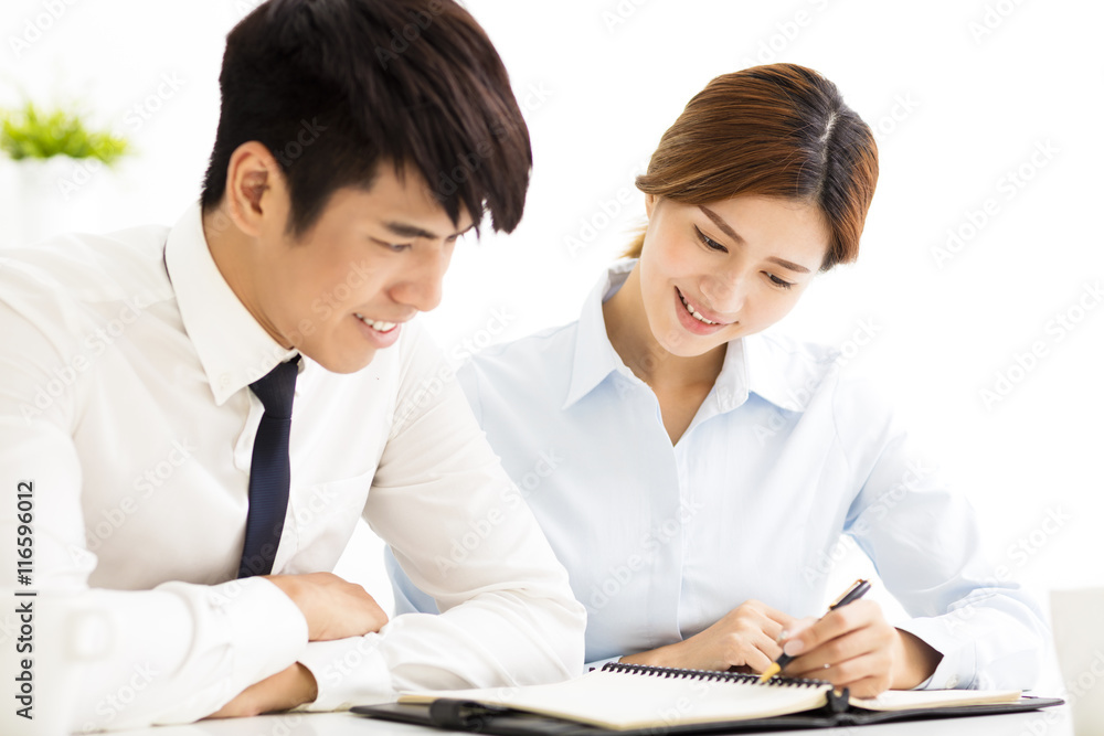 business man and woman discussing doucment in office business man and woman discussing doucment in office