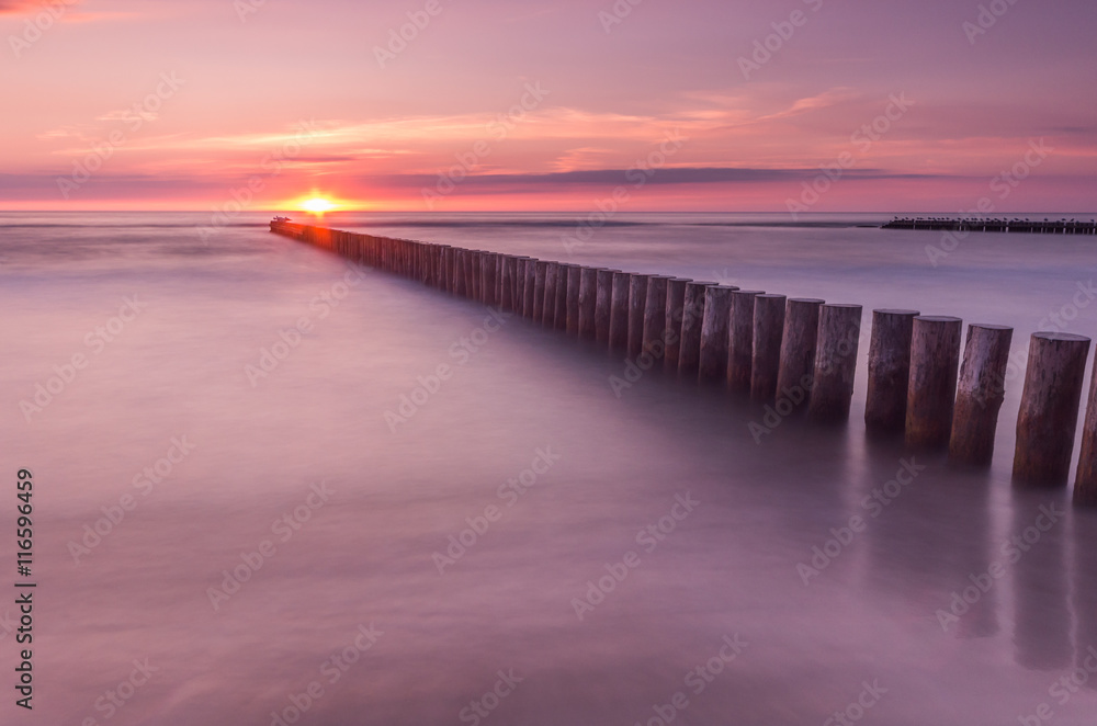 Fototapeta premium Wooden breakwater - Baltic seascape at sunset, Poland