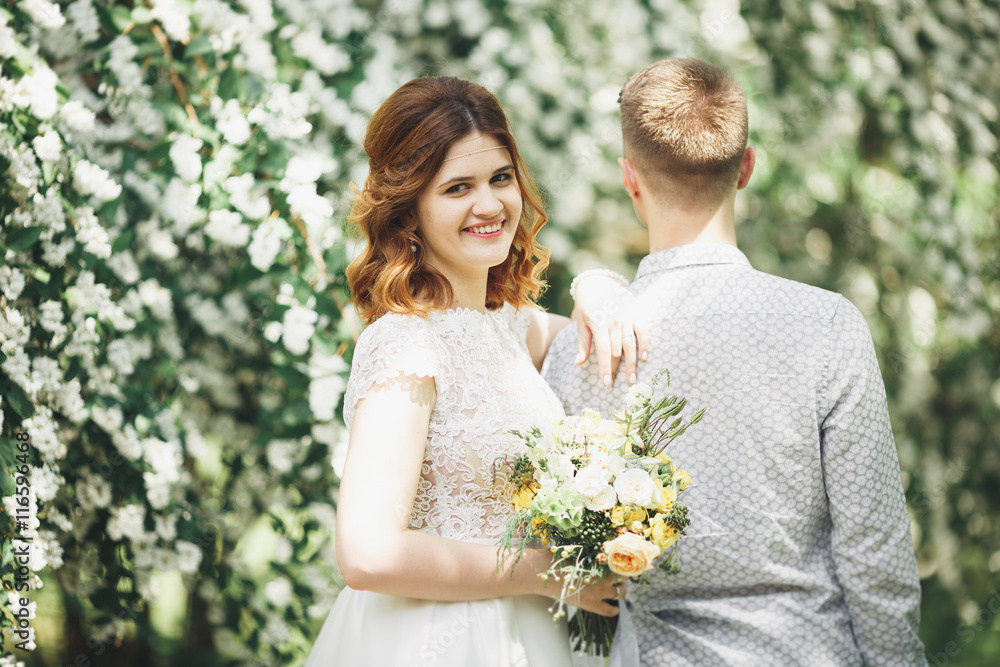 Happy wedding couple walking in a botanical park Happy wedding couple walking in a botanical park