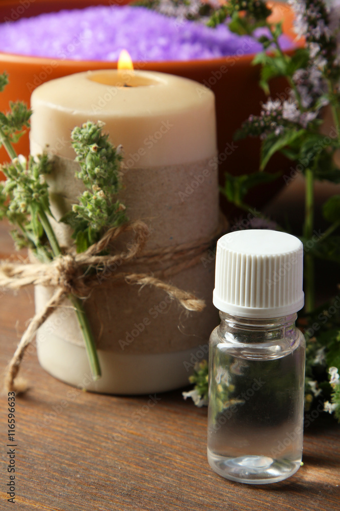 Essential oil on a wooden background. The concept of aromatherapy.