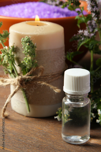 Essential oil on a wooden background. The concept of aromatherapy.