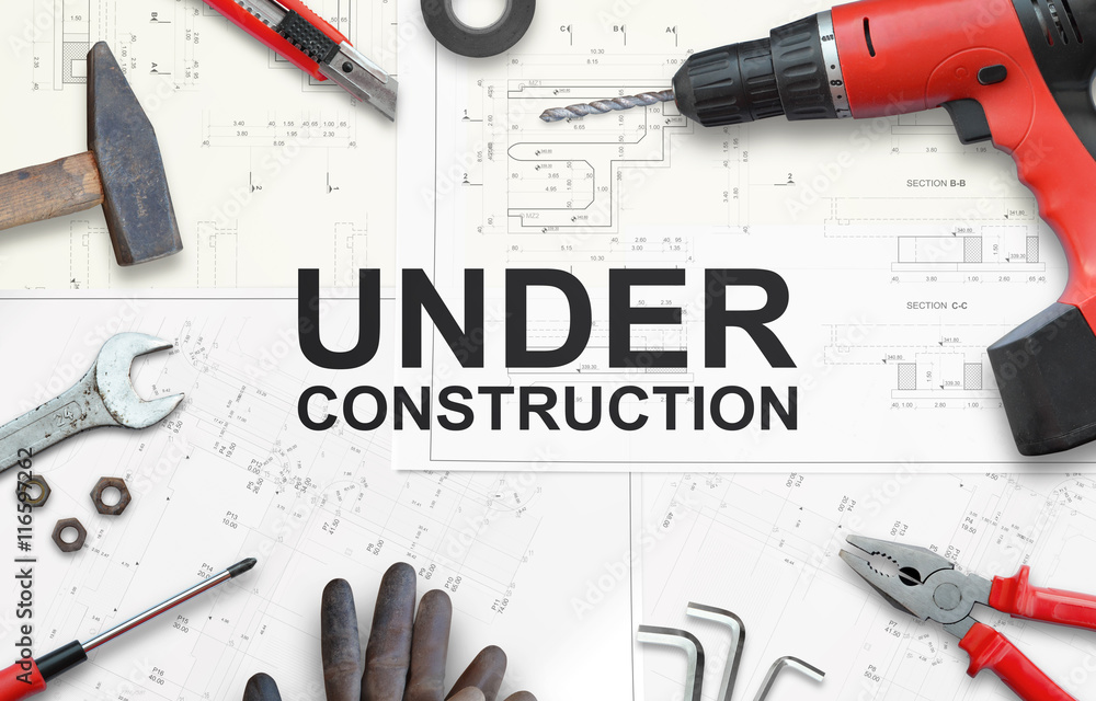 Under construction text with tools for home repairs. Top view. - obrazy, fototapety, plakaty 