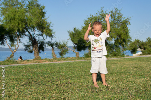 Little boy in park near beach