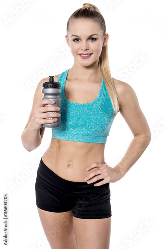 Fitness woman holding sipper bottle over white
