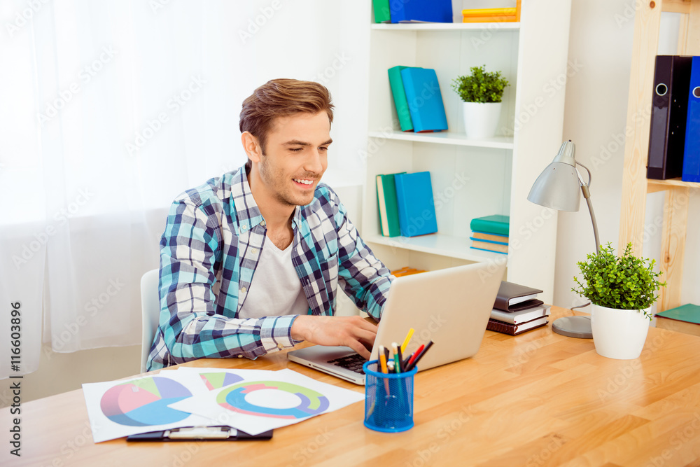 Portrait of happy young man working with laptop Portrait of happy young man working with laptop