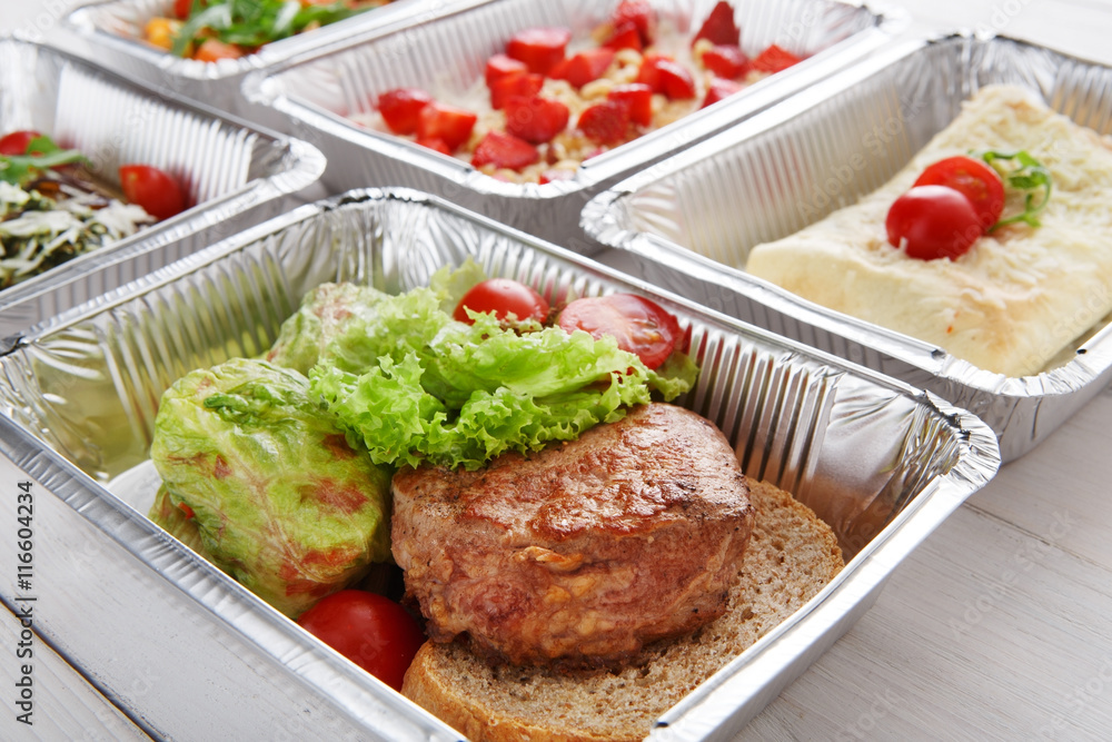 Healthy food take away in boxes, top view at wood Healthy food take away in boxes, top view at wood