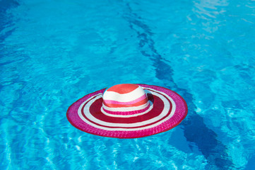 Pink sunhat at swimming pool