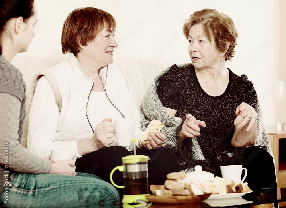Portrait of mature and young women with tea