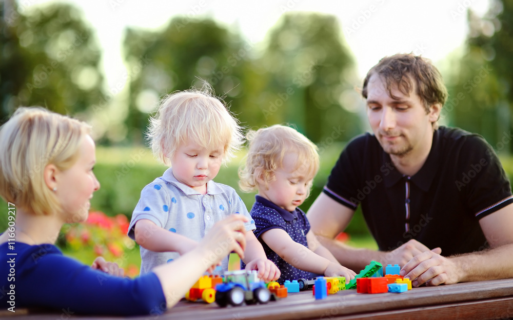 Young family with their children playing with toys Young family with their children playing with toys