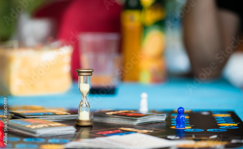 board game with an hourglass, chips and cards