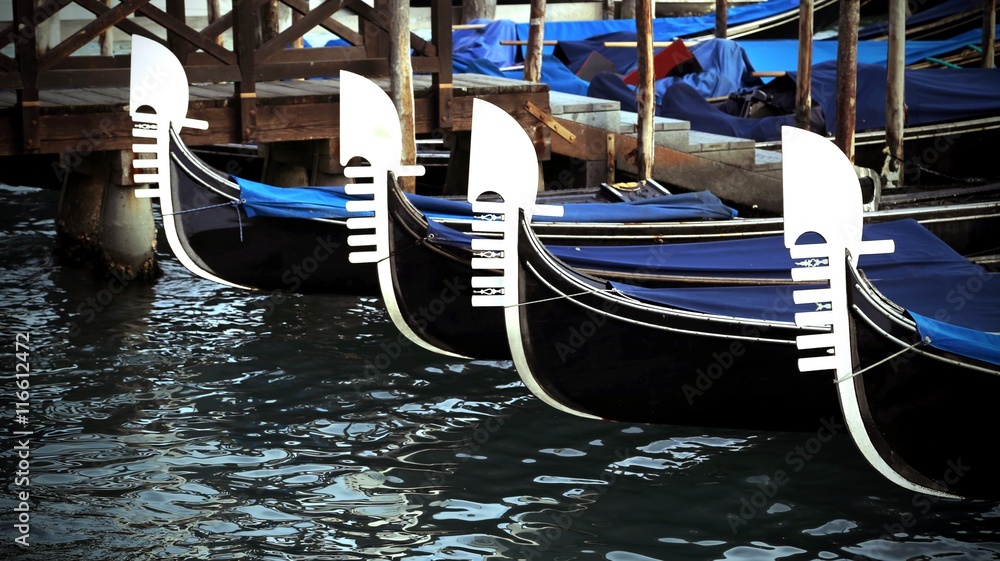 four prows of Venetian gondolas with the characteristic shape of