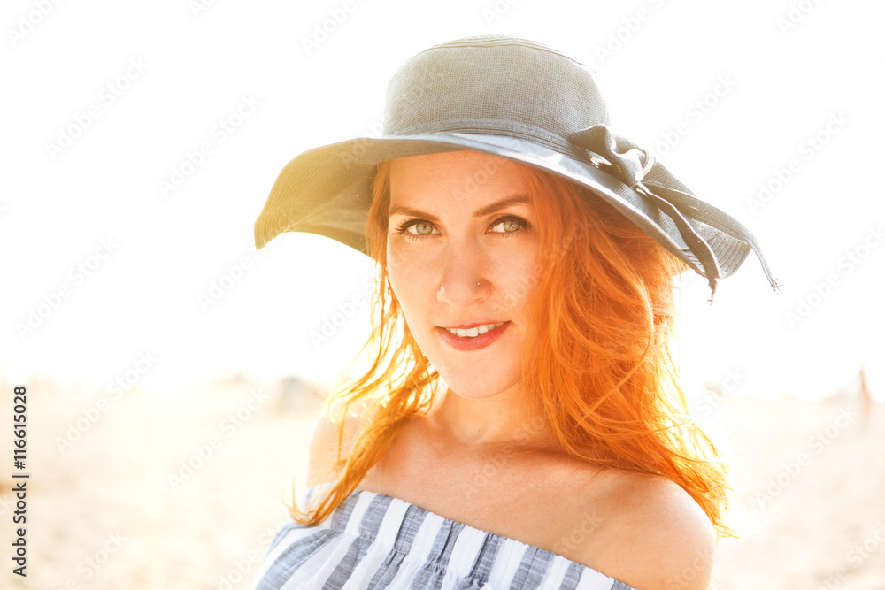 Summer holidays and vacation concept. Girl in hat standing on the beach
Summer holidays and vacation concept. Girl in hat standing on the beach