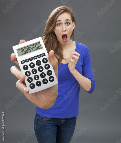 Fotografie stunned young woman expressing panic, mistake or shocking financial news