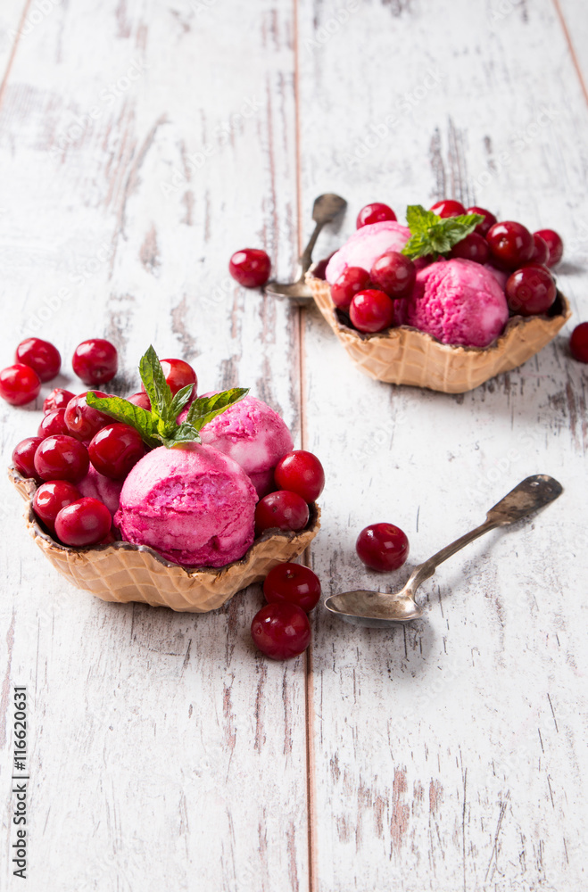 Ice Cream sour cherry, summer sundae with fresh fruits on wooden background. 