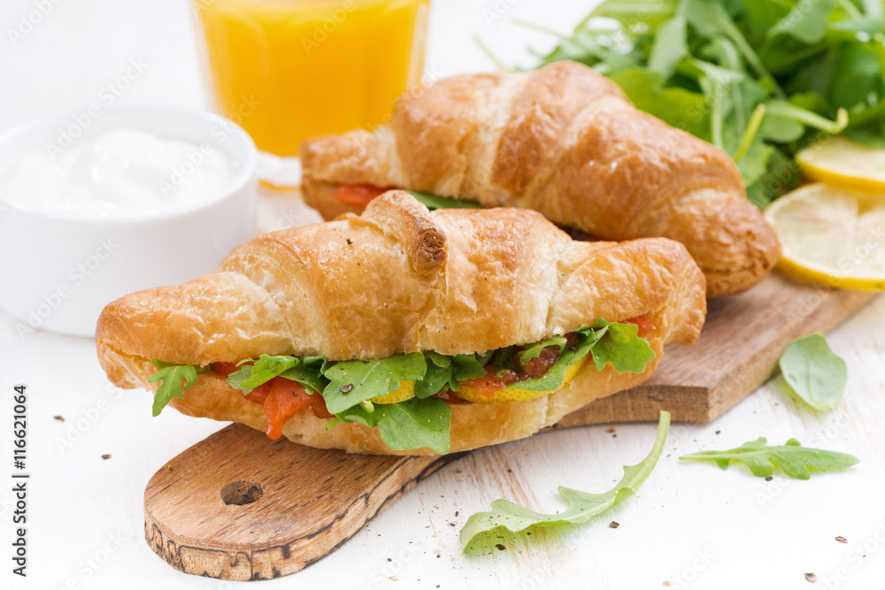 fresh croissant stuffed with fish and arugula for breakfast fresh croissant stuffed with fish and arugula for breakfast