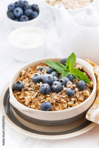 berry crumble with oatmeal in a ceramic form on white table